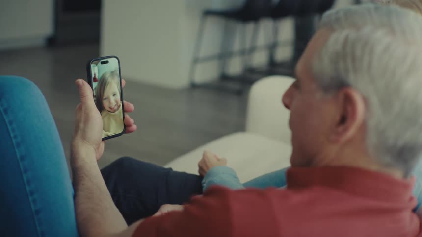 Grandparents talk with their granddaughter on a video call