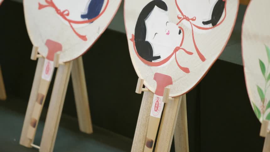Fans with drawings on them are on display