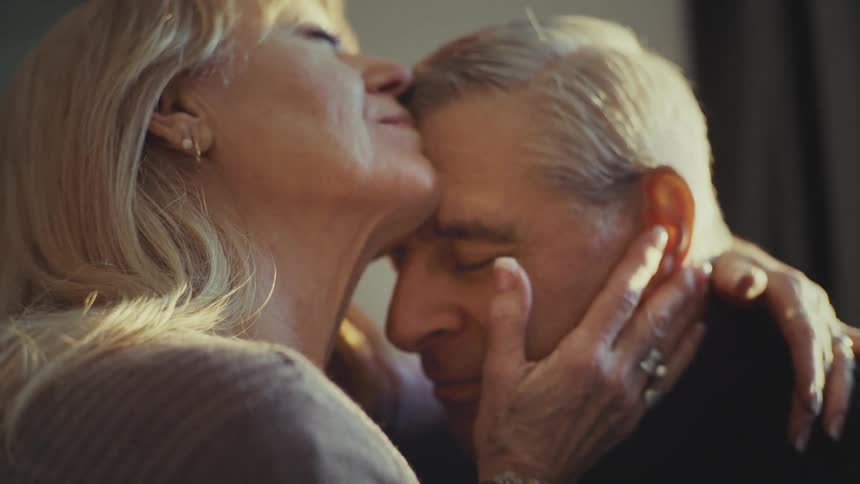 Footage of an elderly man and a woman sharing an intimate and romantic moment