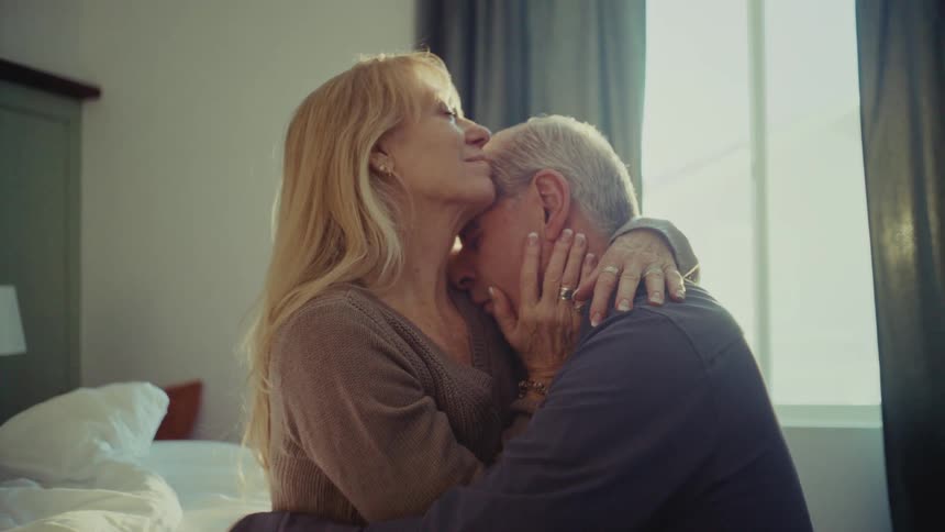 A footage of a man and a woman sharing a romantic moment indoor