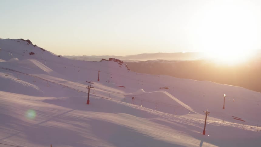 The sun sets near the mountains