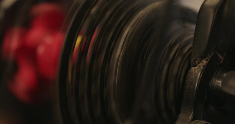A closeup shows the rotating black hub and chain of a bicycle wheel