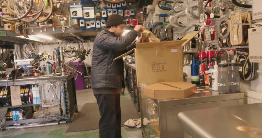 A man removes items from a cardboard box
