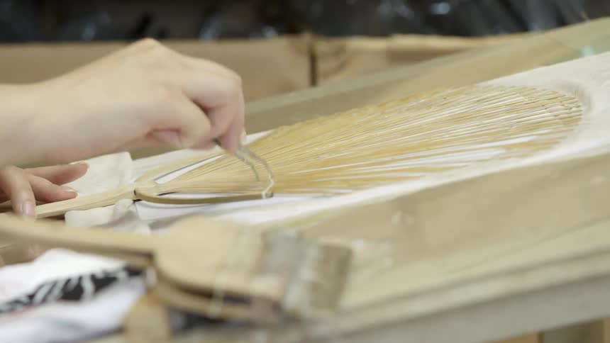 Person assembling a paper fan