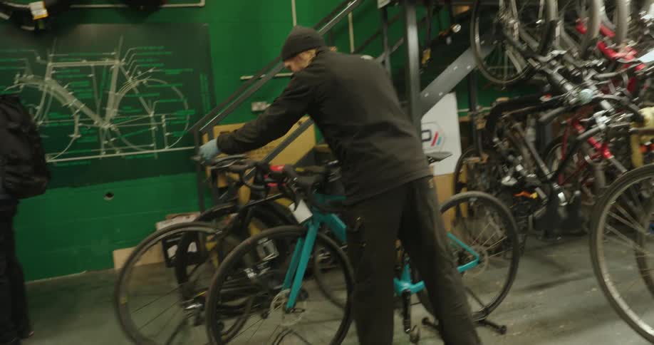 An employee moves bokes around in the bike shop