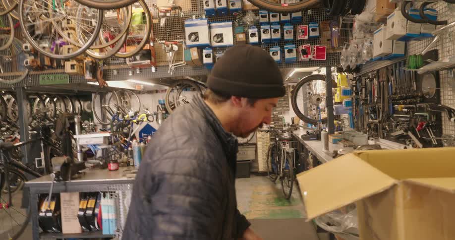 Man removing parts in a bicycle workshop