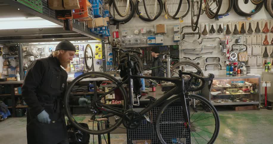 Two men are working in the bike shop