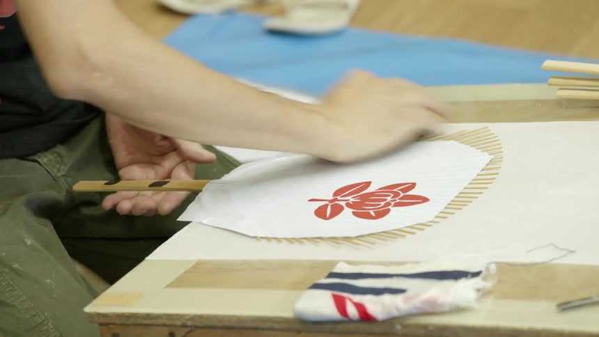 Person making paper fans