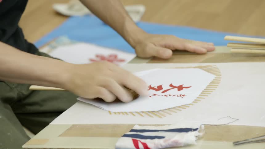 A person is working putting together a fan