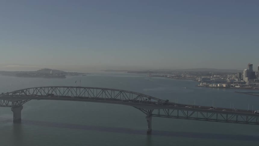 Cars drive on a bridge over water