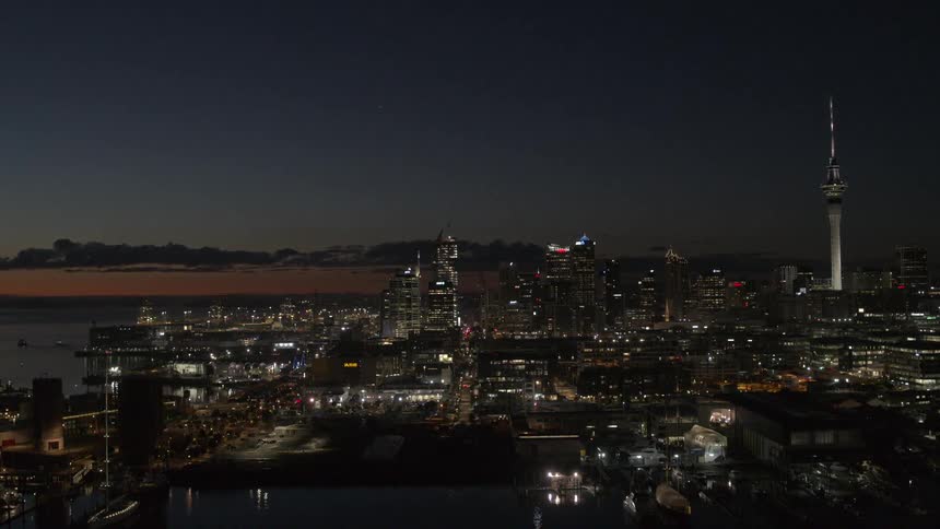 The city windows are brightly lit at night