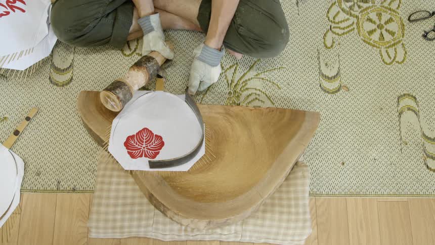 Person pounds the shape of a paper fan