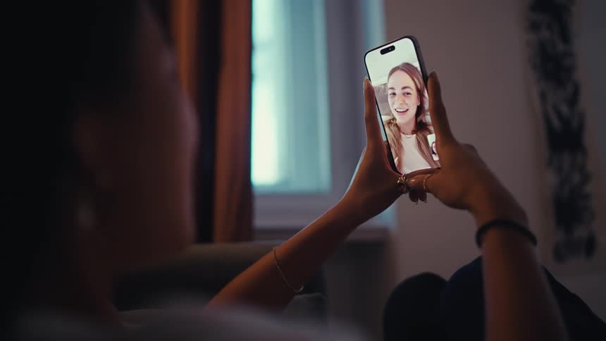 Two girls talk on a video call on their cell phones