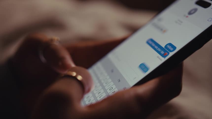 A person sends an i love you text message on their smartphone