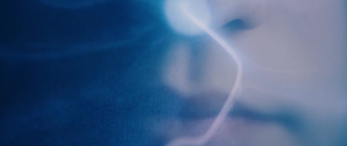 A person touches their nose on a plasma ball