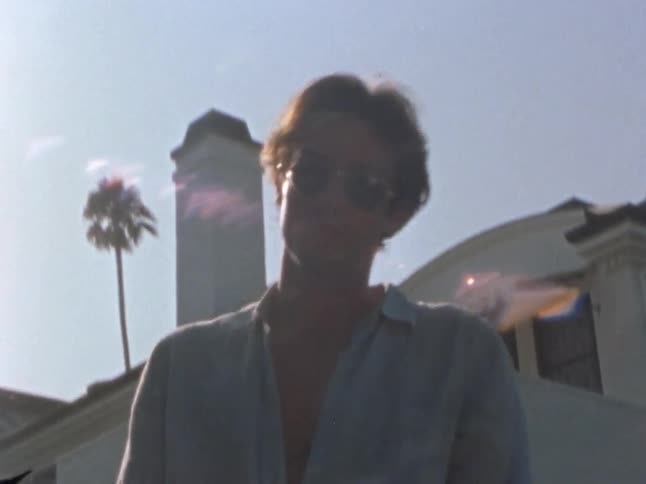 A man walks over with a martini in his hand
