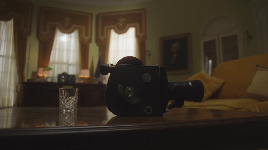 A video camera sits on a coffee table in a living room