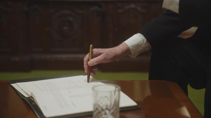A man taps his pen on a document