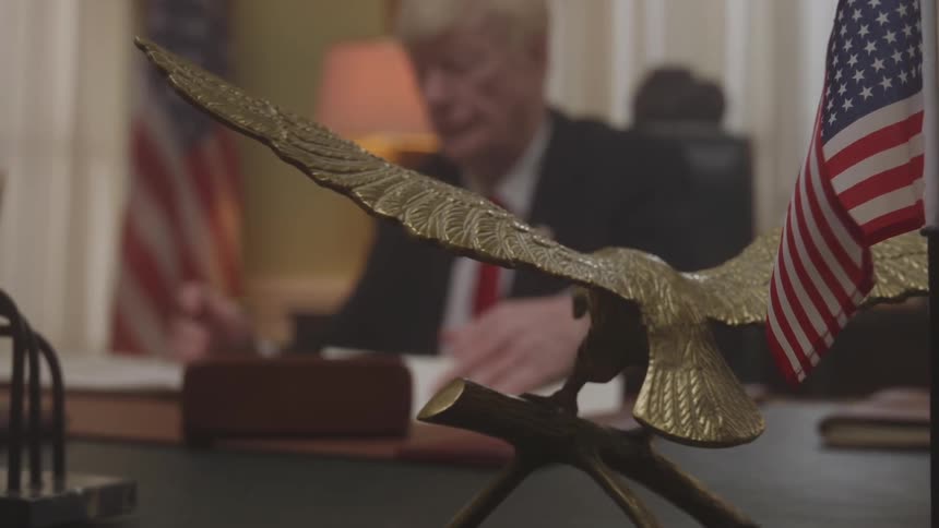 The president is doing paperwork at his desk