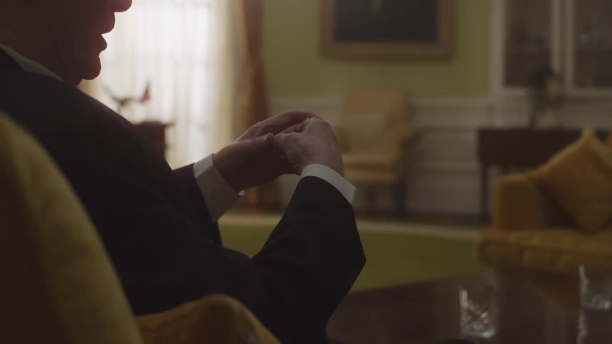 A man moves his hands while talking in the oval office