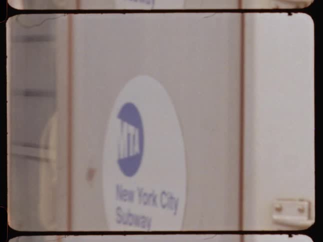 A new york city subway train departs from an outdoor station captured on film