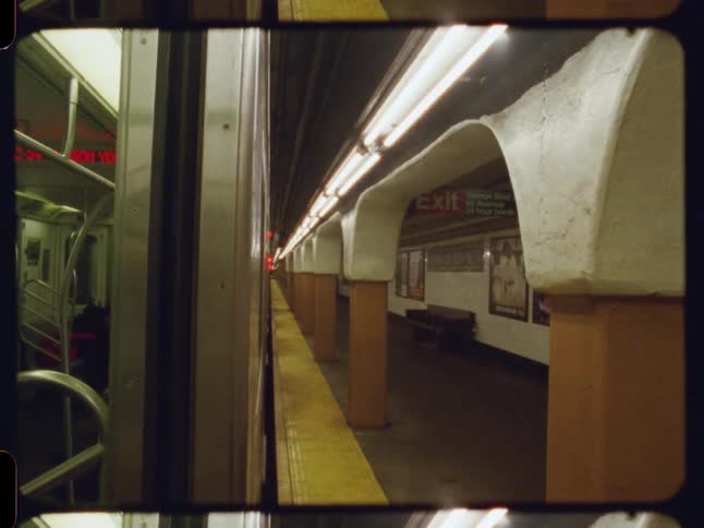 People are sitting in the train stopped in the subway