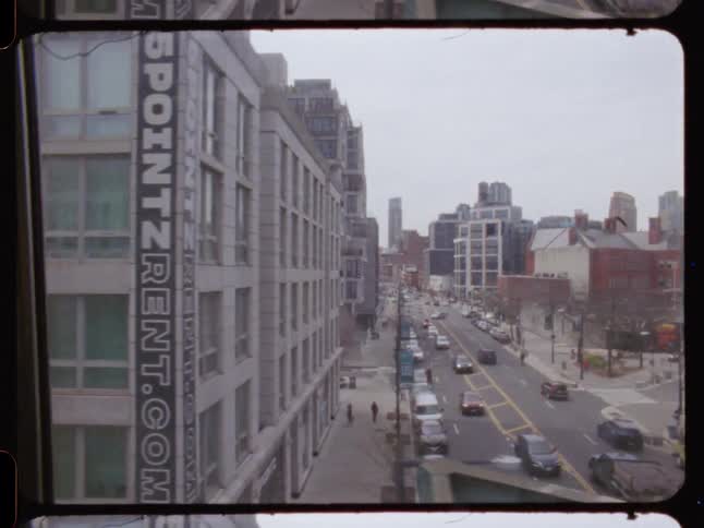 Traffic passes buildings near downtown during the daytime