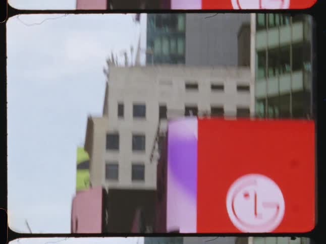 Old film footage of Times Square NYC shows the bustling billboards and architecture of times square