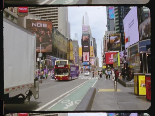 Traffic moves through Times Square NYC on a street partially closed due to street construction during the daytime