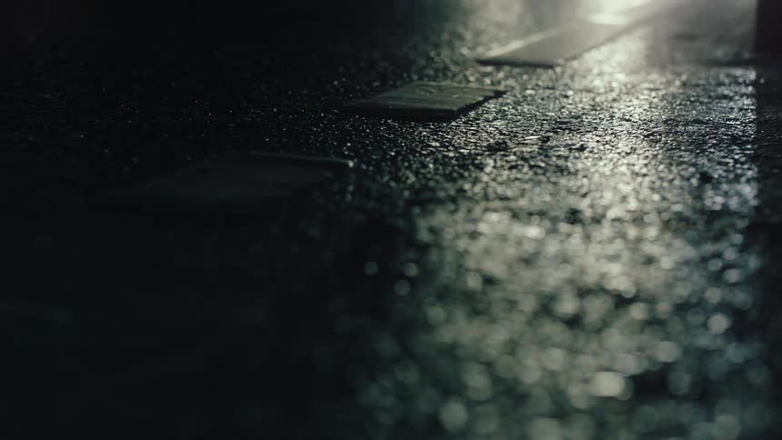 Vehicles drive on the wet road at night