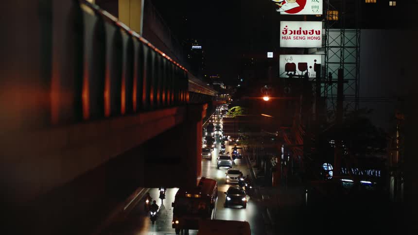 A large busy street full of traffic at night