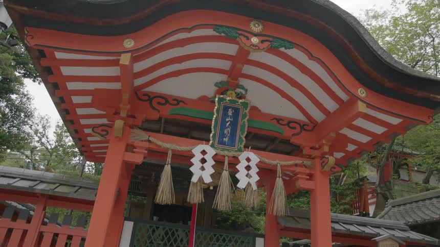 Red chinese style gazebo with tassels and paper decorations hanging on it
