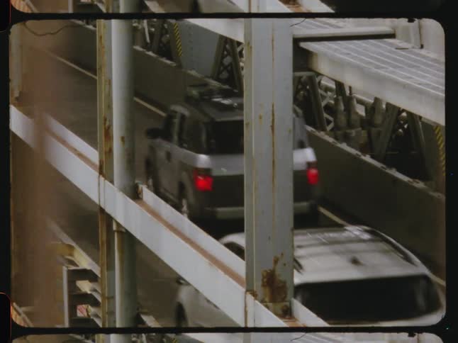 Traffic drives along a multi lane bridge during the daytime
