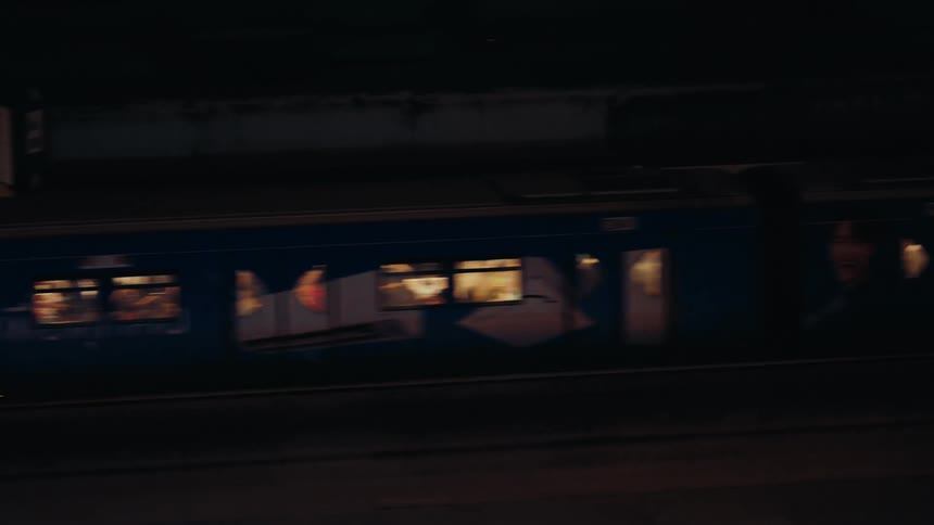 A train full of people pass by at night