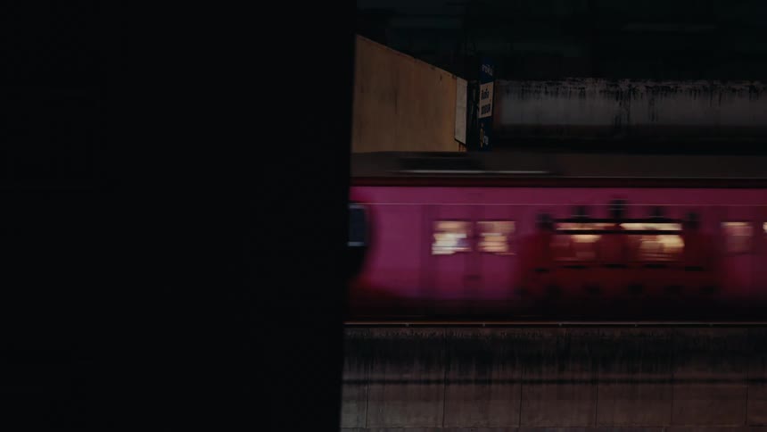 Passenger train passes through the city at night