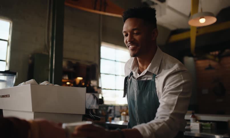 A man serves coffee in the restaurant