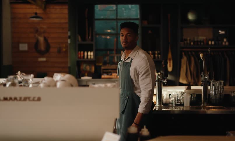 Man in apron working in a coffee shop