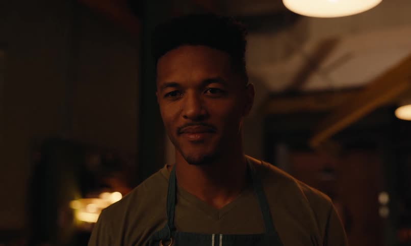 Portrait of a man in an apron in an indoor space