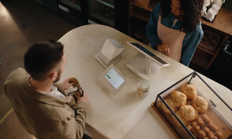 A man takes out cash to pay for his order in the restaurant