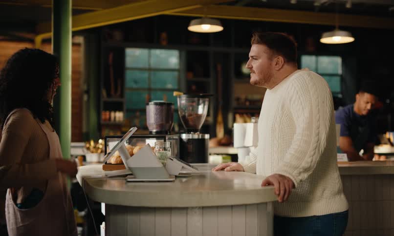 Customer placing order directly at the cashier in a coffee shop