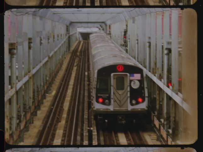 A city train is slowly moving on railroad tracks