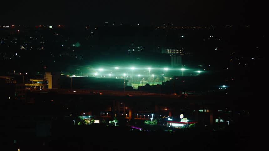 Traffic moves through a city outside of a stadium