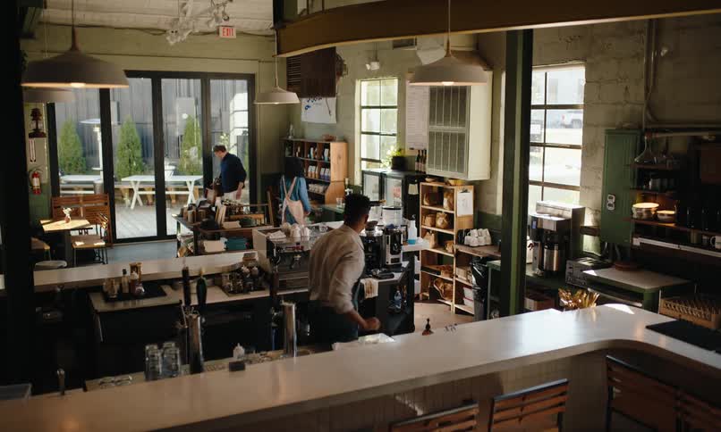 Barista moves to the counter to take the order of a customer
