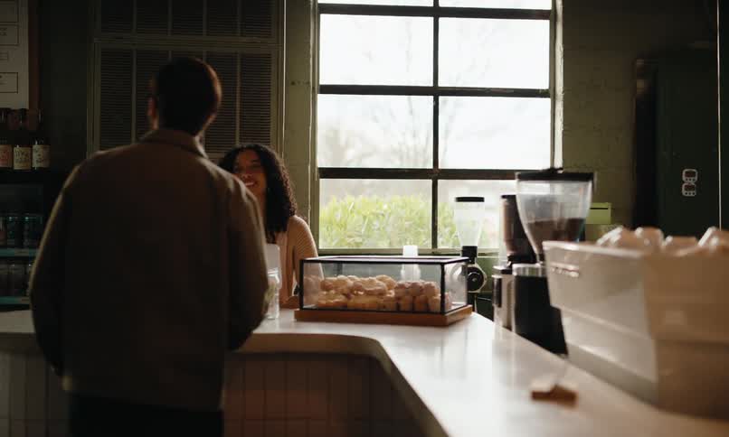 Customers interacting with staff at a coffee shop