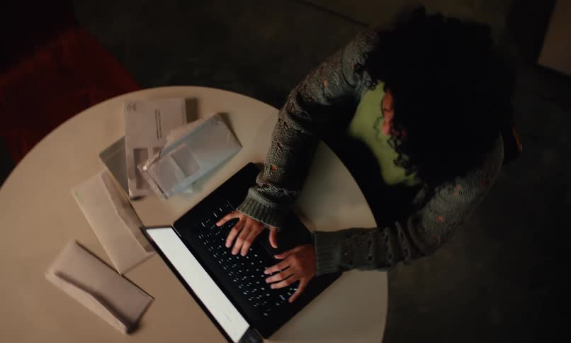 A footage of a lady operating a laptop