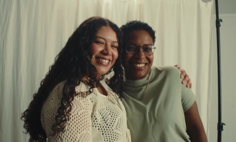 Two smiling women hugging each other