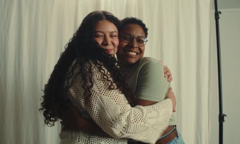 Two women hug each other