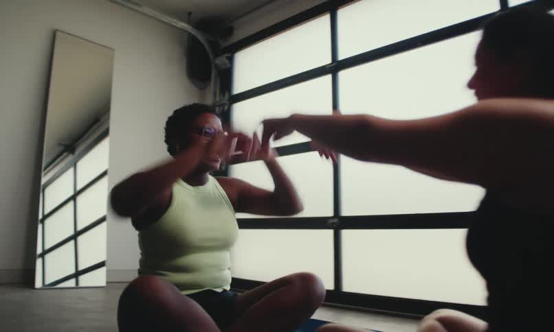 Two women high five on the yoga mats