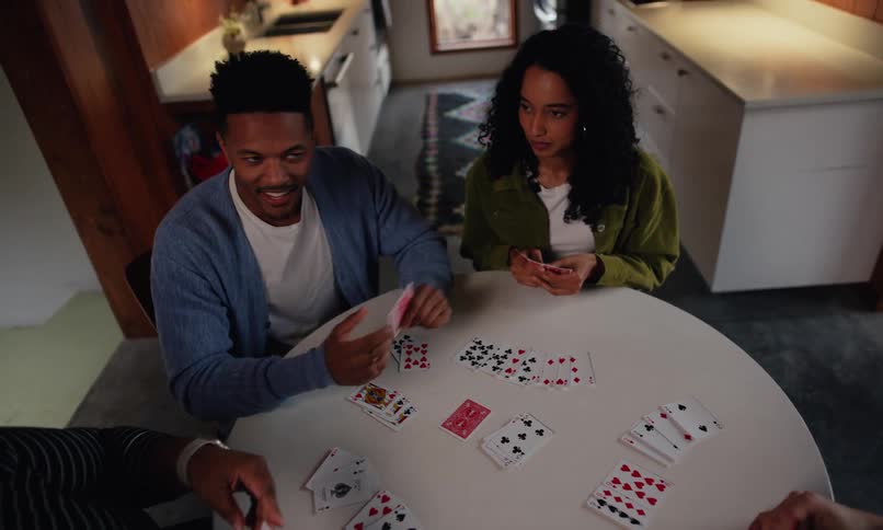 Friends are having fun playing a card game together