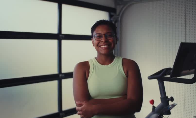 Portrait of a woman crossing her arms with happy facial expression
